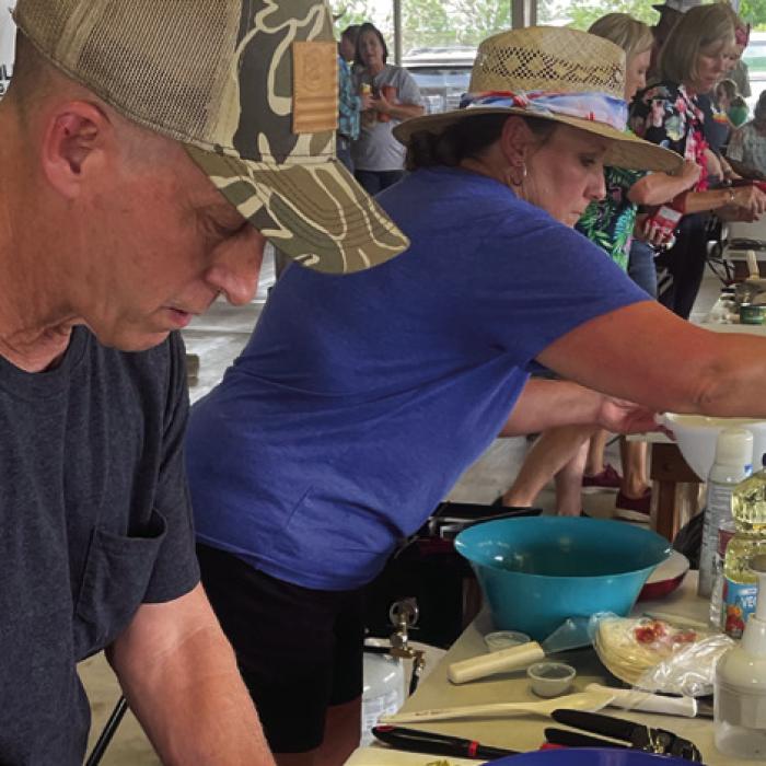 The Ellinger Chamber of Commerce hosted the 86th Annual Ellinger Tomato Festival this past weekend. Festivities included a “Chopped” cooking competition. Pictured above is a scene from the final round on Saturday, May 27. Team “Tropical Mushrooms” won the competition. Team members were John LeBlue and Kelly Vitek, pictured above. Photo by Andy Behlen