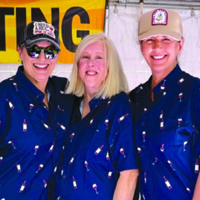 Wine shirts worn by volunteers Linda Clann, Cindy Stephens and Stephanie Fitzpatrick in the ArtWalk wine booth.
