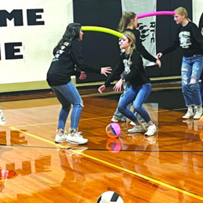Volleyball team members paired up for a special test of teamwork competition during the pep rally.