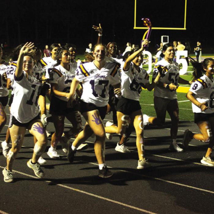 At Wednesday night’s community homecoming pep rally La Grange senior girls athletes began the event by running into the stadium with a ‘torch’ to light a flaming “LG.’