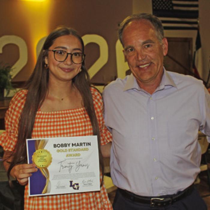 The Bobby Martin Gold Standard female award winner (named after an LHS employee who passed away this year) was Trinity Yanis, left, presented by coach Barry Donovan.