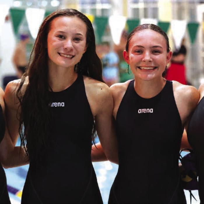 The relay team of (from left) Paige Michalke, Eleanor Carey, Adysen Janacek and Celeine Fabre etched their names into the record books, clocking in at 1:57.92 in the 200-yard freestyle relay. Photo by Katy Michalke