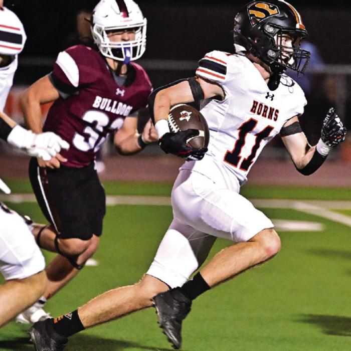 Nicholas Goode carries the ball upfield Friday night. Photo by Stephanie Steinhauser