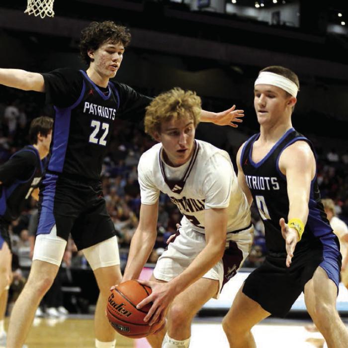 Kole Schmitt looks for a teammate as he is hemmed in by Turkey Valley defenders Kanyon Taylor (22) and Carson Tucker (0) during third-quarter play in the Alamodome. Photo by Ken Sury
