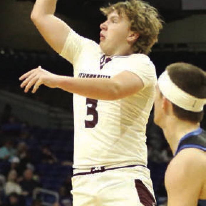 Kasen Kocian hits a jump shot in the third quarter in front of Turkey Valley senior Kanyon Taylor (22). Kocian finished with eight points for the Lions. Photo by Ken Sury