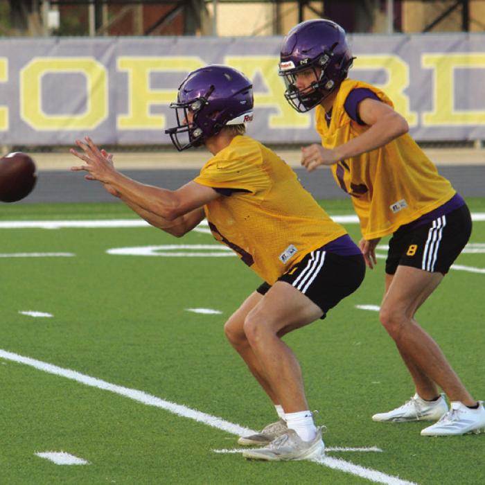 La Grange starting quarterback Eli Gillum take a snap as Klayton Michalke awaits the hand-off. Photos by Jeff Wick