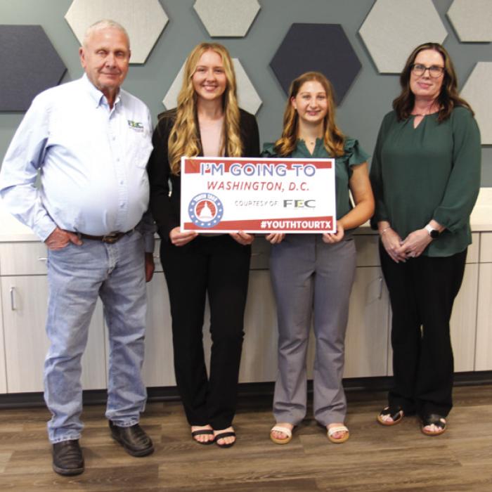 FEC Board President Joseph Kruppa, left, and FEC Youth Tour Coordinator Tracy Denton, right, congratulate Laney Bludau, from Hallettsville High School, and Gretchen Sacks from Round Top-Carmine High School, winners of FEC’s 2026 Governmentin- Action Youth Tour contest.