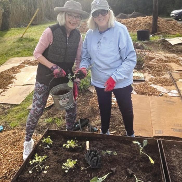 Karen Bookout and Cindy Stephens planting the first bed at Fayetteville Park.