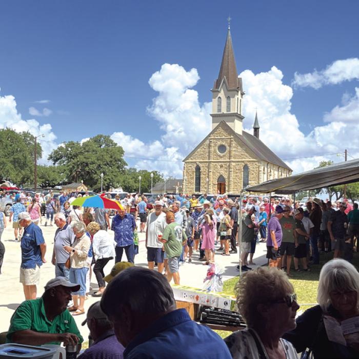 With St. Mary’s Church in the background, the line of people waiting for the fried chicken and stew meal in the church hall was hundreds of folks long about noontime.