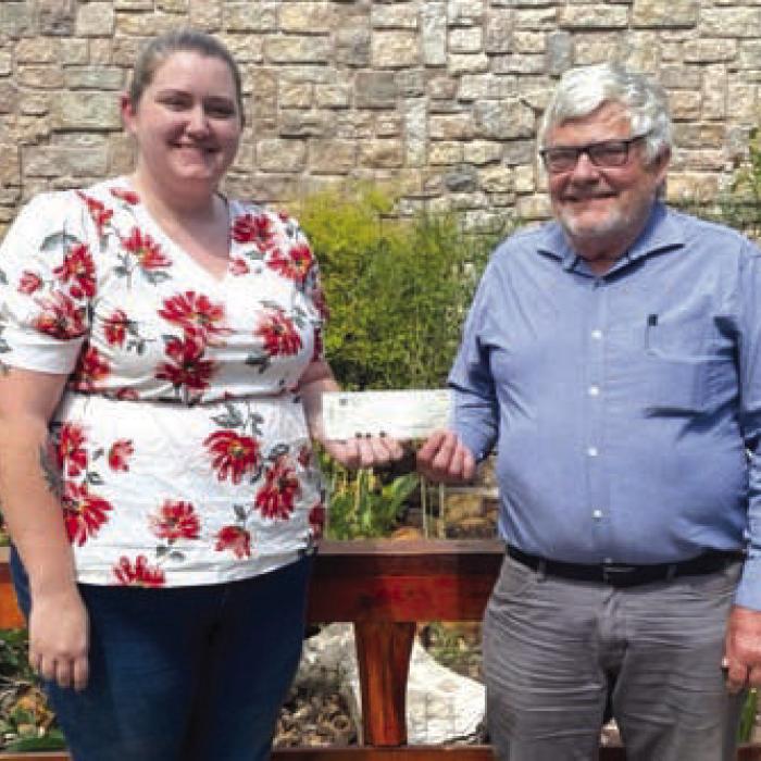 Pictured are Children’s Advocacy Center Executive Director Meagan Webb (left) accepting the donation from Steve Hillhouse.