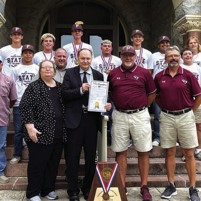 Members and Coaches of the Flatonia high school baseball team were honored on the steps of the Courthouse on Wednesday, July 24, 2024. Coaches Shawn Bruns and Mark Migl and their team were given a proclamation signed by County Judge Dan Mueller and County Attorney Peggy Supak. Also pictured is Gary Dusek of KVLG KBUK the voice of the Bulldogs.