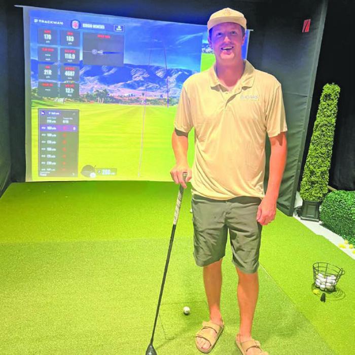 Mac Brooks is shown above, left, holding the ball he hit a hole-in-one with last week at Frisch Auf! Valley Country Club, and right, at the new golf simulator at Mac’s Daqs that he credits with helping his golf game.