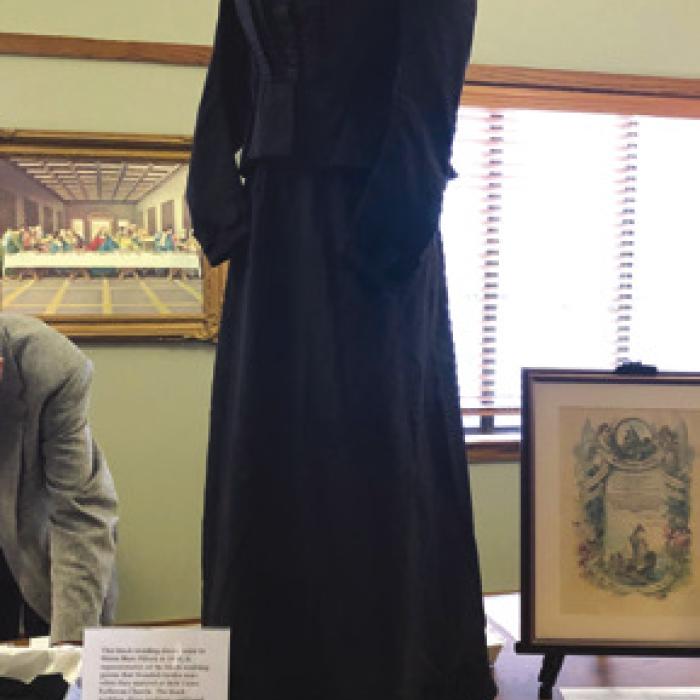 This black wedding dress, worn by Minna May Pillack in 1896, is representative of the black wedding gowns that Wendish brides wore when they married at Holy Cross Lutheran Church. The black wedding dress tradition continued until around 1910.