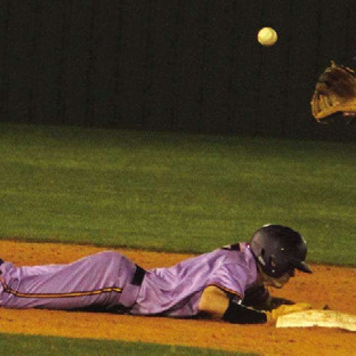 La Grange’s Brayden Horton slides back into second on a pickoff attempt Tuesday. He would later score the game-tying run. Photo by Jeff Wick