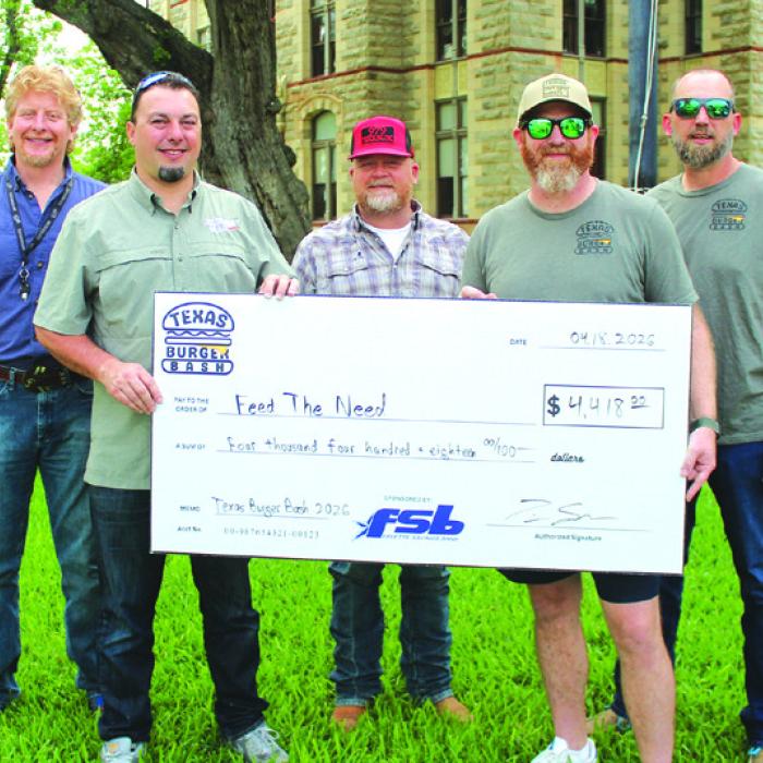 Director of The Texas Burger Bash Tim Scarborough, front, right, presents a check to Jonah Beyer founder of Feed the Need. Back row, left to right: Director of the La Grange Feed the Need program Jeremy Finch and Sam Tucker and Kevin Ulrich of the Texas Burger Bash.