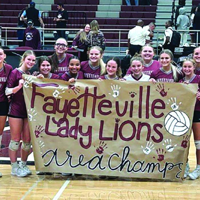 The members of the Fayetteville volleyball team celebrate their area round victory in Waller Tuesday over Hull-Daisetta.
