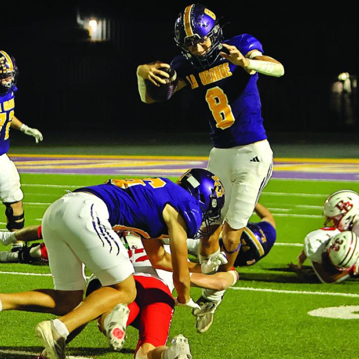 Above: La Grange’s Dillan Johnson hurdles over Bellville’s Jacolby Walker during Friday’s game. Left: La Grange Klayton Michalka leaps to avoid a tackle during Friday’s game. Photos by Darrell D. Gest