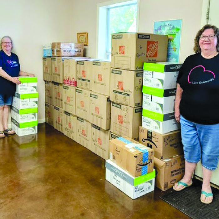 Martin Luther Lutheran Church Women of the ELCA packed the shipment for Lutheran World Relief on Oct. 23. Pictured are Leonita Sanders, left and Colette Wunderlich, right, with the thirty-two boxes to be shipped on Nov. 1. Also helping pack 109 quilts, 32 school kits, and 72 personal care kits were Diana Wunderlich, Nancy Eilers, and Joys Baird.