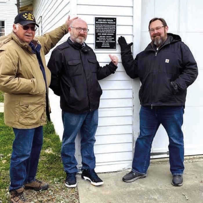 EDC board members Steve Pavlicek, Robbie Hofland and Kevin White in front of plaque commemorating the old fire station restoration projects. Missing board members include Bob Kurtz, Gina Hillock, Mike Clann and John Reynolds.