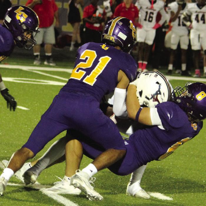 Ramon Ortiz (21) and Ethan Tarnowski (8) make a tackle Friday. Photos by Jeff Wick