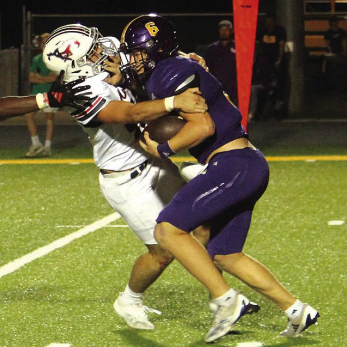 La Grange quarterback Clayton Cooper stiff arms a Madisonville tackler Friday.