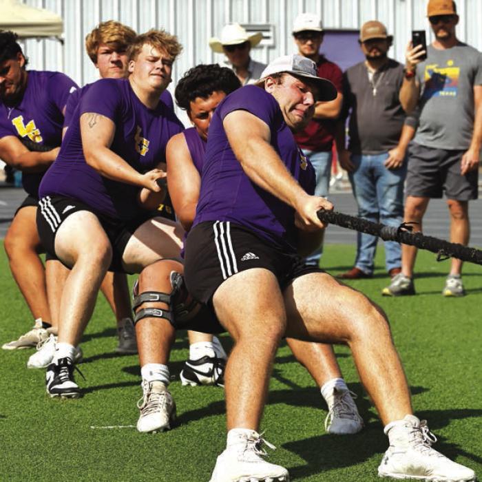 La Grange linemen, with Luke Anderson in front, compete in the tug-of-war portion of the linemen challenge Saturday. Photo by Darrell D. Gest