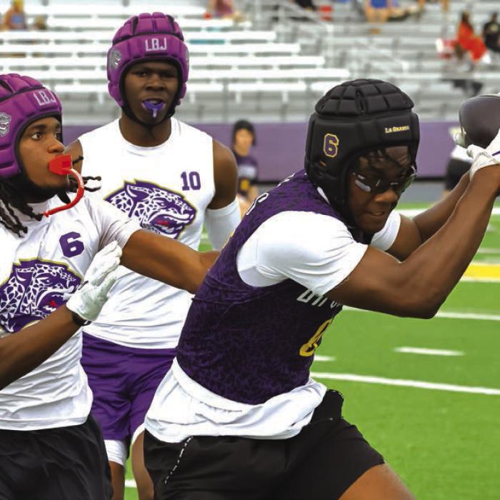La Grange’s Dillon Johnson makes a catch Saturday in front of two Austin LBJ defensive backs. Photo by Darrell D. Gest