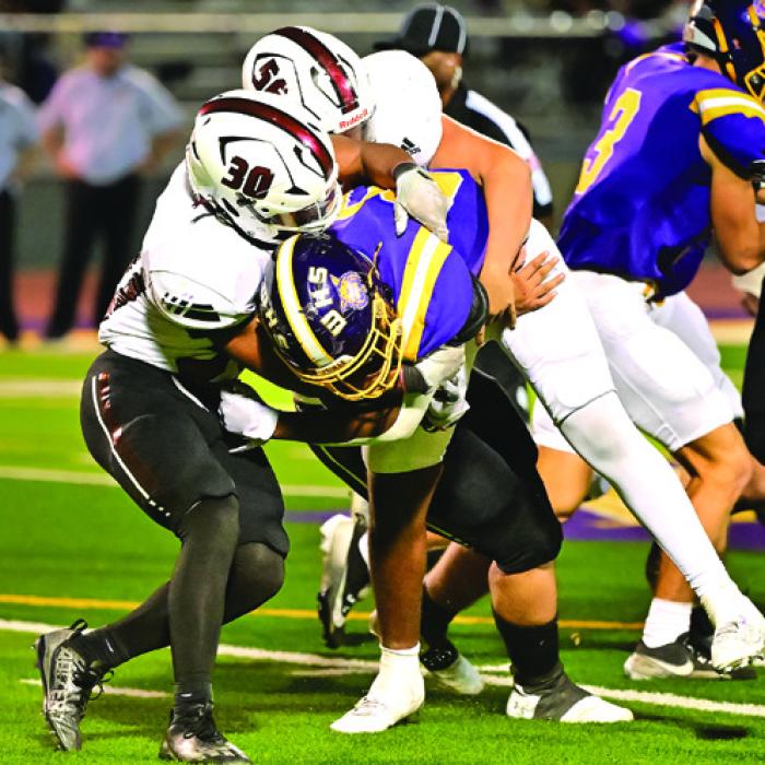 Koren Scott (#30) and Richard Valdez (#56) bring down a Weimar ball carrier in Friday night’s game. Photo by Stephanie Steinhauser