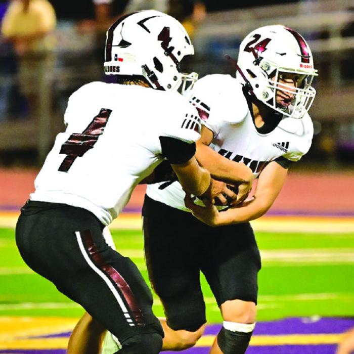 Quarterback Beck Zimmerman hands off to Nathan Aguillon. Aguillon then picks up a first down for Flatonia. Photo by Stephanie Steinhauser