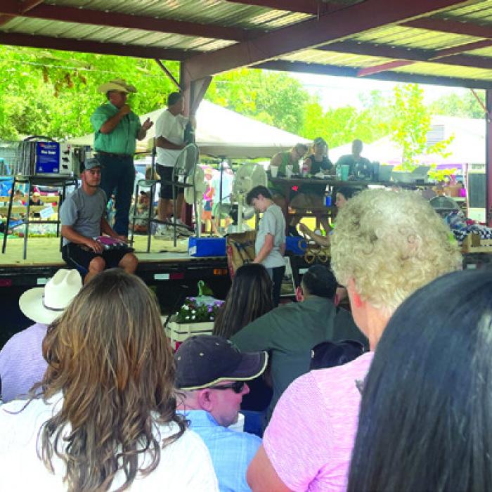 Auctioneer Joe Orsak called out the bids during the live auction in Ammannsville on Sunday. Photos by Andy Behlen