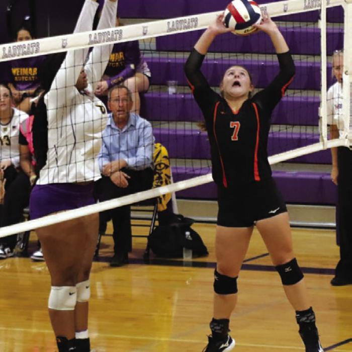 Schulenburg’s Landry Zapalac sets a ball in Friday’s loss to Weimar. Photo by Audrey Kristynik