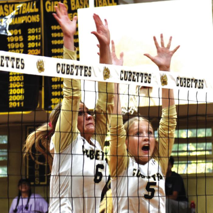 Round Top-Carmine’s Jill Eilers and Hayden Kasmiersky jump to block a hit by Thrall Friday. Photo by Paul Kipp