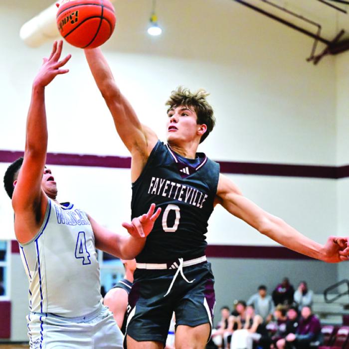 Fayetteville’s Enoch Loafmann blocks a shot in last week’s tournament game against Waelder. Photo by Stephanie Steinhauser