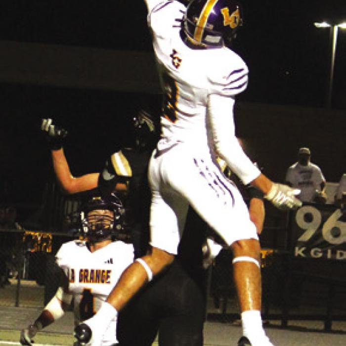 Top left: Da’von Giscome lowers his head to fight for extra yardage Friday. Top right: Mason Kleiber picks his way through the Giddings defense on his way to a 38-yard touchdown reception. Bottom left: Oliver Gunn and Le’Kayvion Broussard join forces to make this tackle Friday. Bottom right: La Grange’s Max Dixon leaps high to bat away this Giddings pass attempt. Photos by Jeff Wick