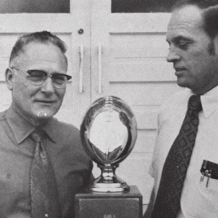 Tom Walker (right) presents the state championship trophy to Schulenburg ISD Superintendent A.C. Winkelman (left) following the big game in December 1972. Mr. Winkelman had been instrumental in bringing Tom to Schulenburg. Photo source: 1973 Schulenburg Roundup Yearbook.