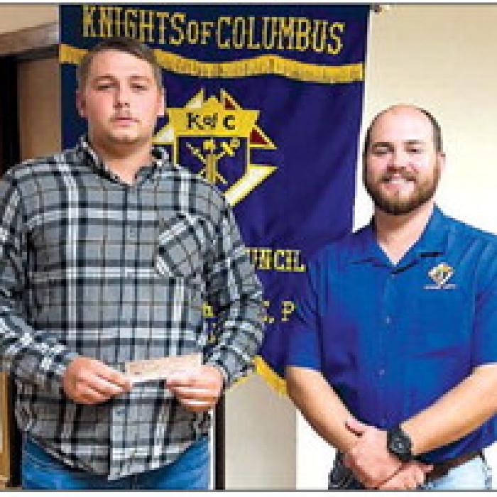 Receiving a Knights of Columbus Scholarship in honor of deceased member Monsignor Harry Mazurkiewicz is Michael Kosler.