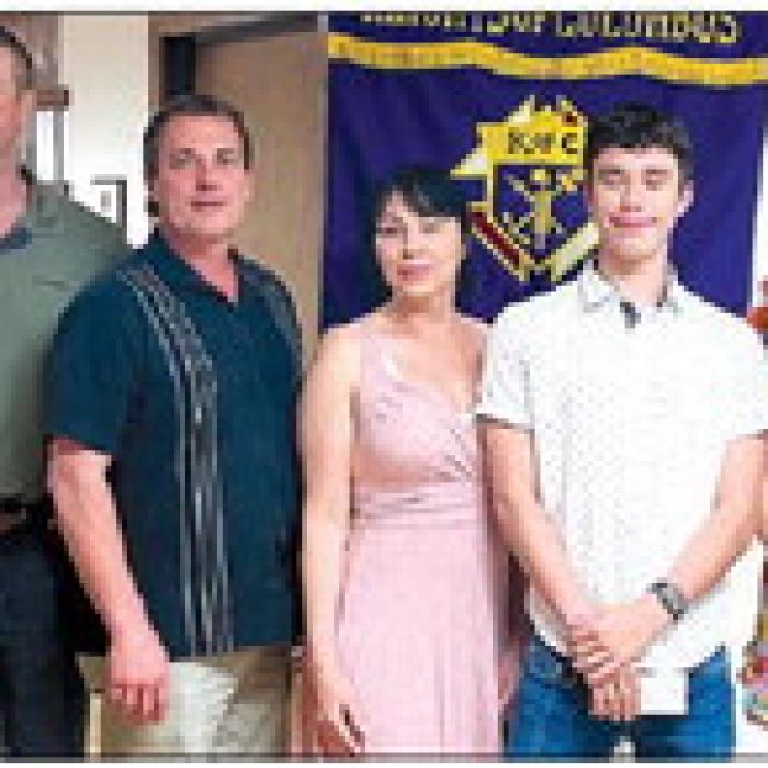 Receiving a Knights of Columbus Scholarship in honor of deceased member Bernard Mozisek is Christopher Krhovjak.
