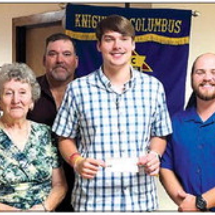 Receiving a Knights of Columbus Scholarship in honor of deceased member Arnold Janda is Zachary Janda.