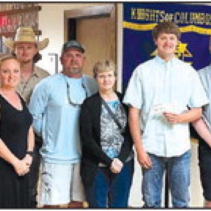 Receiving a Knights of Columbus Scholarship in honor of deceased member Edwin Hughes is Ben Gerik.