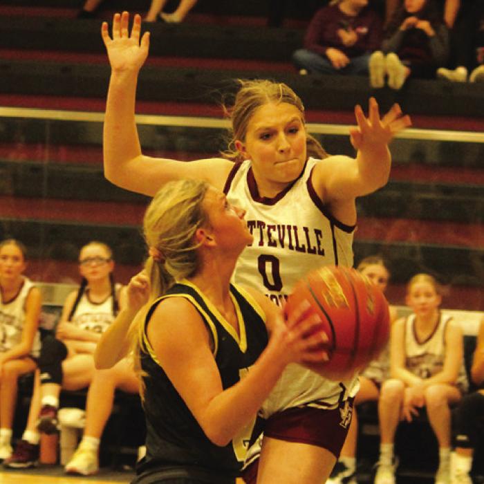 Fayetteville’s Reagan Moreau jumps to try to block the path to the basket of Round Top-Carmine’s Tess Eilers. Photo by Jeff Wick