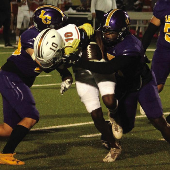 La Grange’s Holdyn Cooper, left, and Jaylances Johnson, right. sandwich this ballcarrier Friday. Photo by Jeff Wick