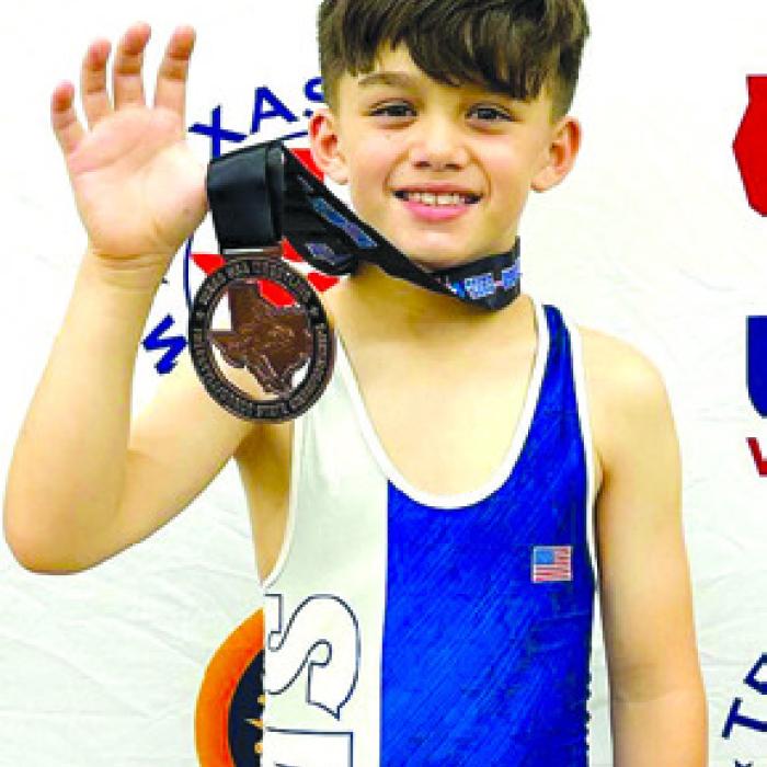 Kathy Chlumsky’s grandson, Hunter Dong, and his 3rd place state wrestling metal.