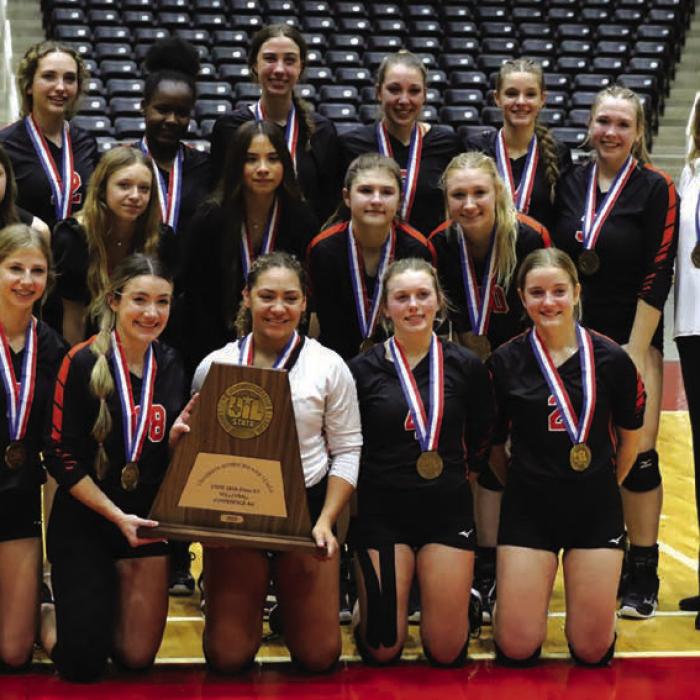 The members of the Schulenburg volleyball team pose with their state bronze medals and their state semifinalist trophy after their loss to Iola in Wednesday’s state volleyball semifinals in Garland. Photo by Audrey Kristynik