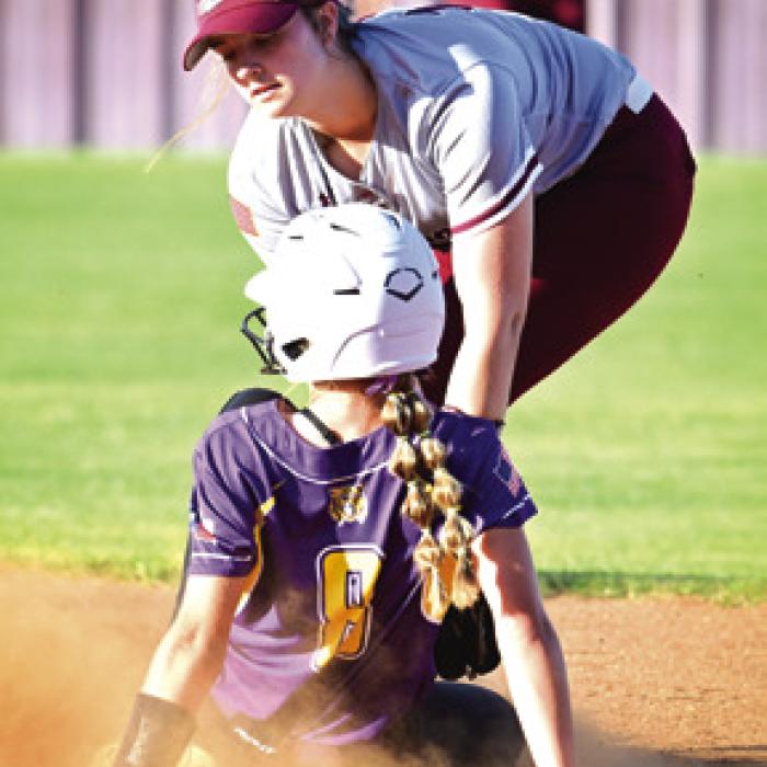 Flatonia’s Abbie Uzzell takes the throw from catcher Katie Templeton to tag out a Lady Wildcat attempting to steal. Photo by Stephanie Steinhauser