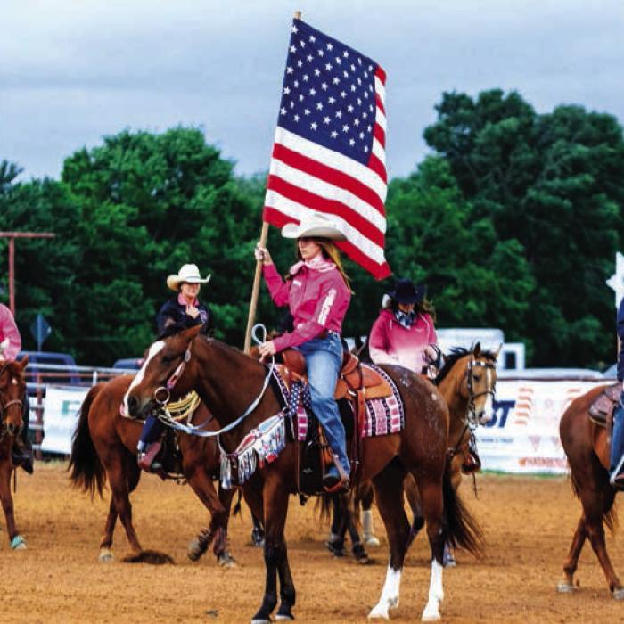 Teagan Kallus of Fayetteville carried out the American flag during the opening ceremonies Saturday night.