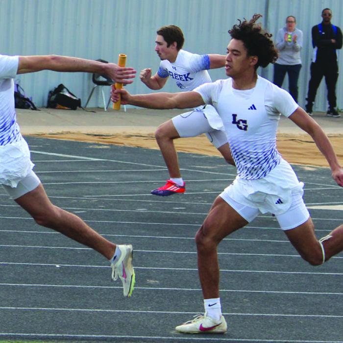 La Grange’s Dwodney Thompson hands the baton to Tre Supak in the last exchange of the boys 4x100 relay. The Leps finished fourth in that race. Photo by Jeff Wick