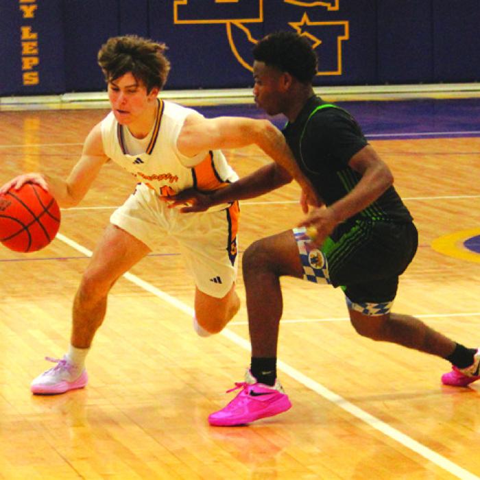 La Grange’s Cordale Knapik drives past a Taylor player in Tuesday’s game. Photo by Jeff Wick