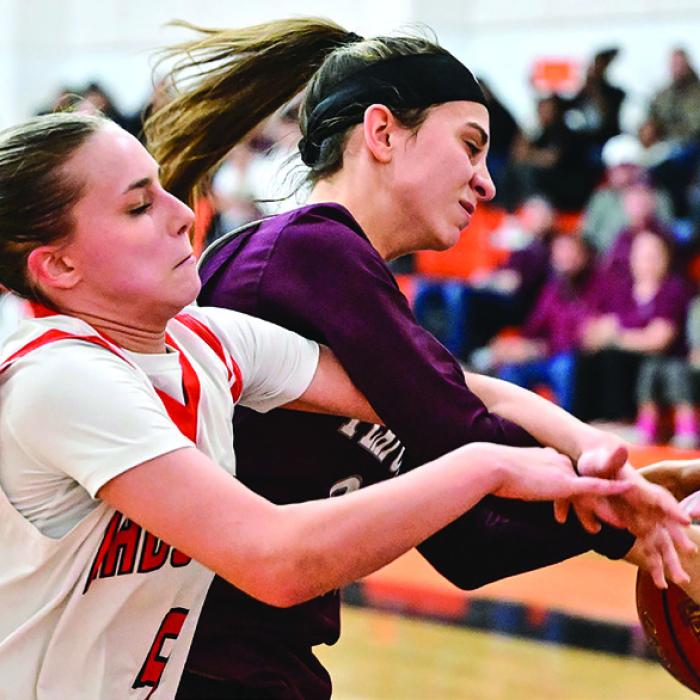 Schulenburg’s Jenna Guentert, left, and Flatonia’s Danielle Vinklarek, right, battle for control of the ball in Tuesday’s district opener. Photo by Stephanie Steinhauser