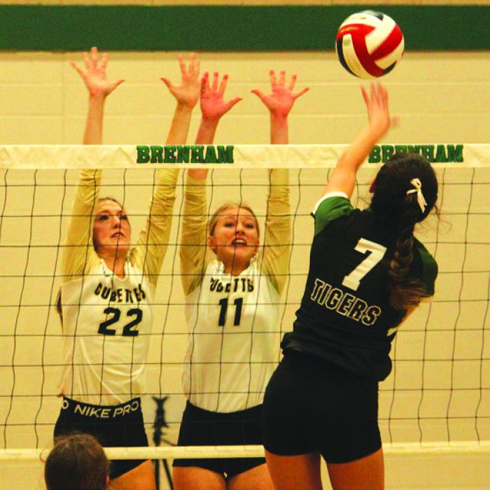 Round Top-Carmine’s Kennedy Flinn (22) and Jessica Rohde (11) jump to try to block this hit by Neches’ Juliana Carrizales in Saturday’s 1A regional final in Brenham. Photo by Jeff Wick
