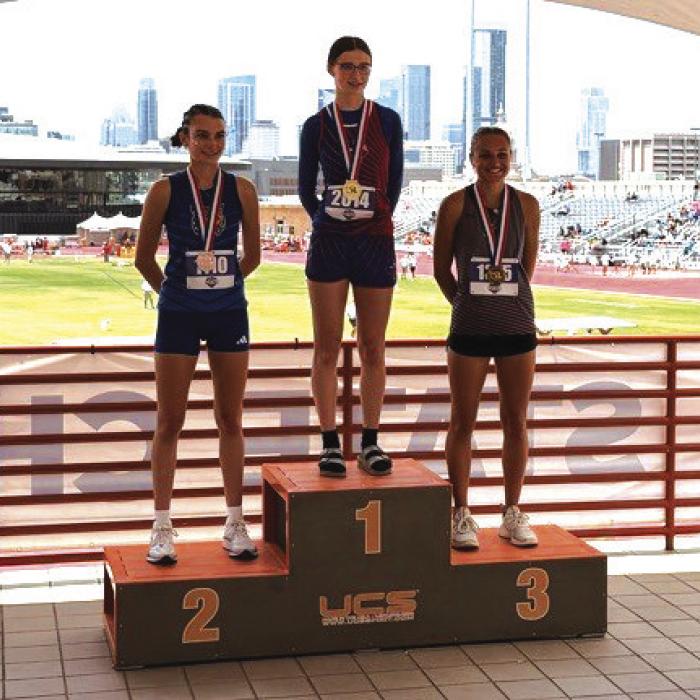 Fayetteville’s Cambree Denham, right, on the medal stand after Saturday’s 1A high jump competition.